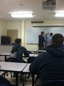 Daly, and fellow broadcast manager put the QBSN meeting's rundown on the board